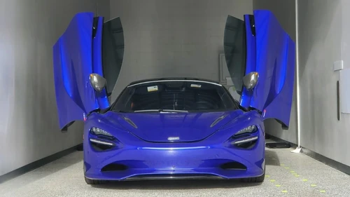 Sports car in a storage unit with butterfly doors open