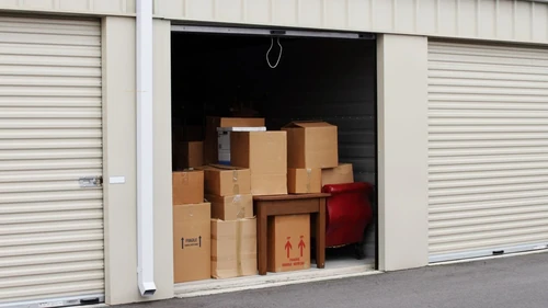 Open storage unit filled with boxes and furniture