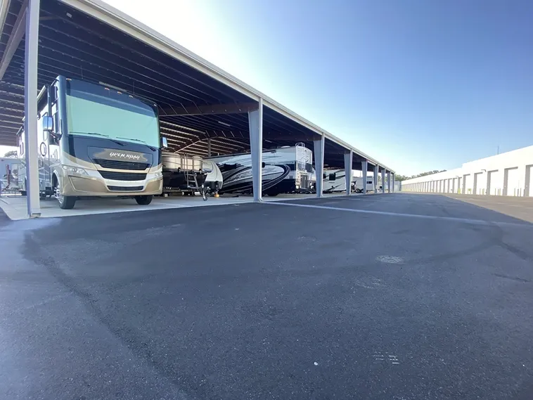 Covered RV and boat parking at Elite Motorcoach Storage.