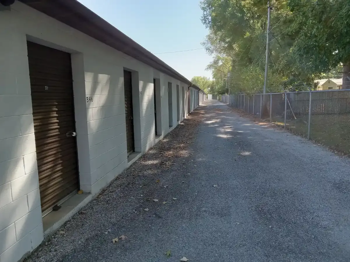 Federal Storage units on gravel path along a fenceline