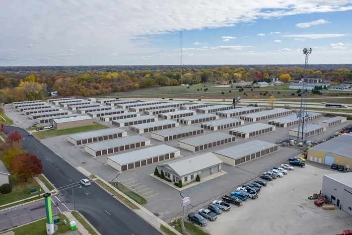 Storage unit building with roll-up doors and paved lot at Osprey Storage Mankato.
