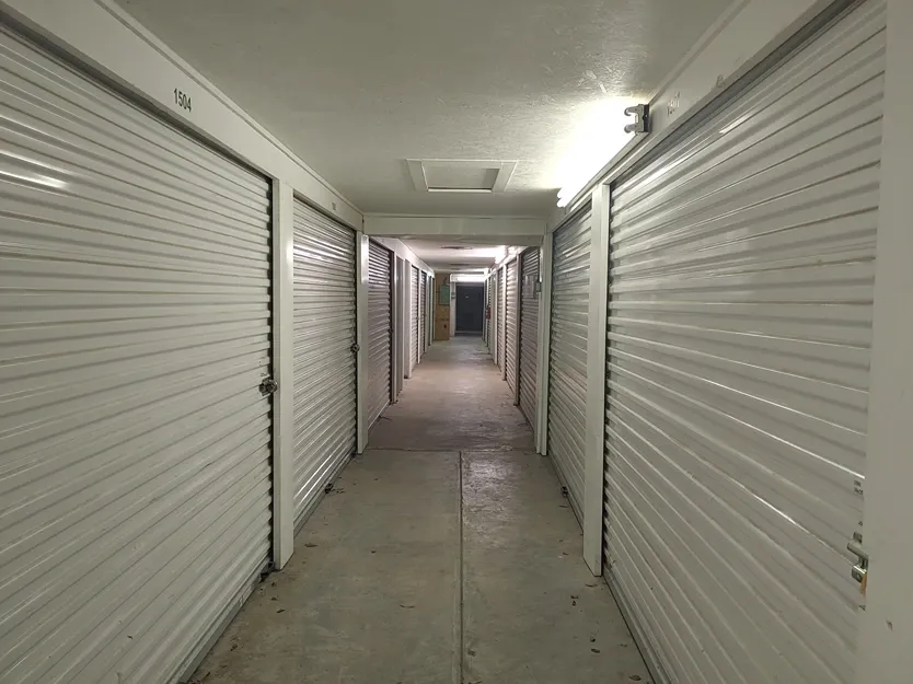 Indoor hallway with bright lighting and unit doors at Town and Country Self Storage.