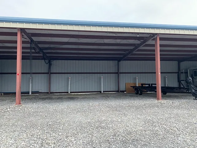 Fenced vehicle storage lot with gravel surface at Volunteer Storage Vonore.